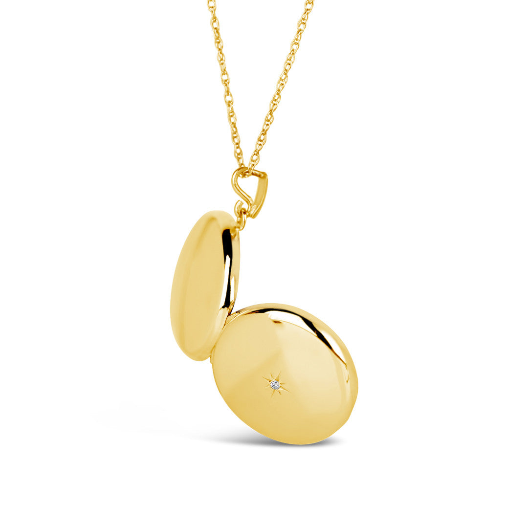 opened gold round diamond locket to show back and front of the locket