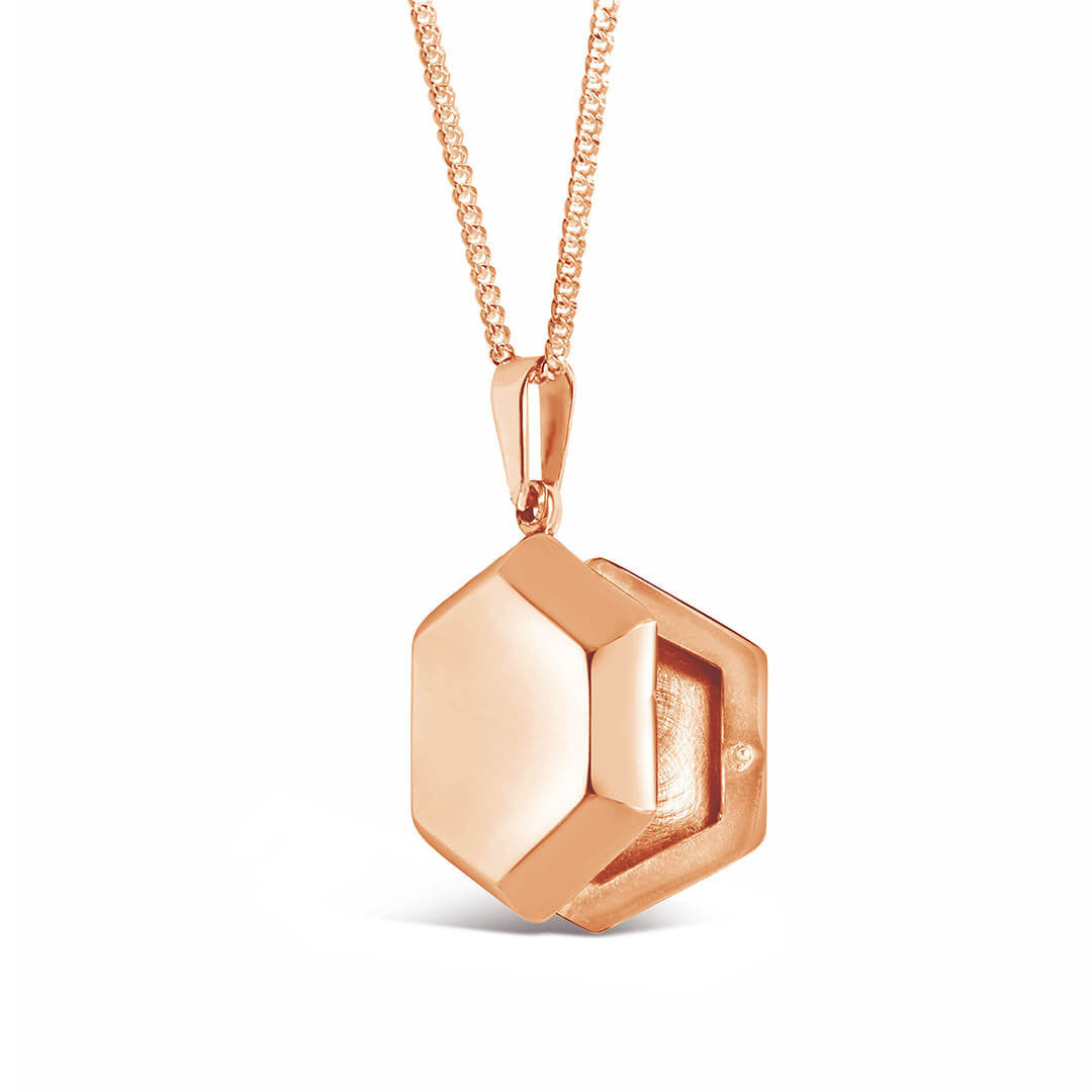opened photo locket in rose gold from the side on a white background