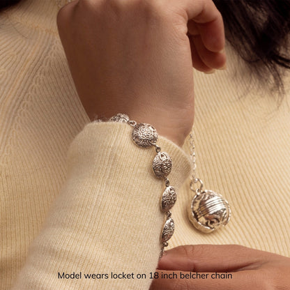 model wearing silver memory keeper locket and bracelet