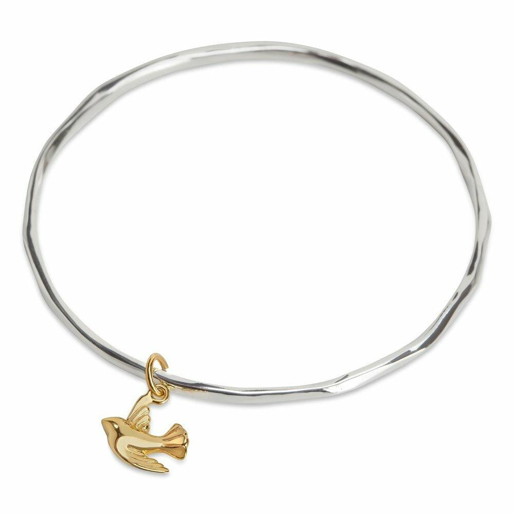 silver bangle with gold bird charm on a whitebackground