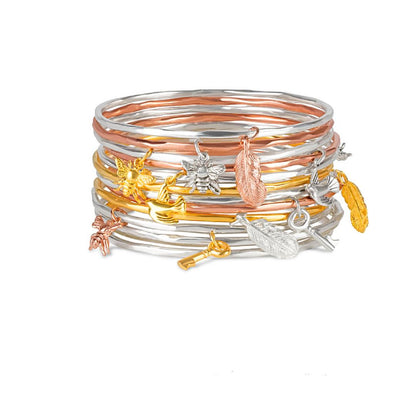 stack of bee bangles on a white background