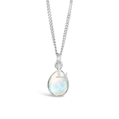 moonstone charm necklace in silver with initial charm on a white background