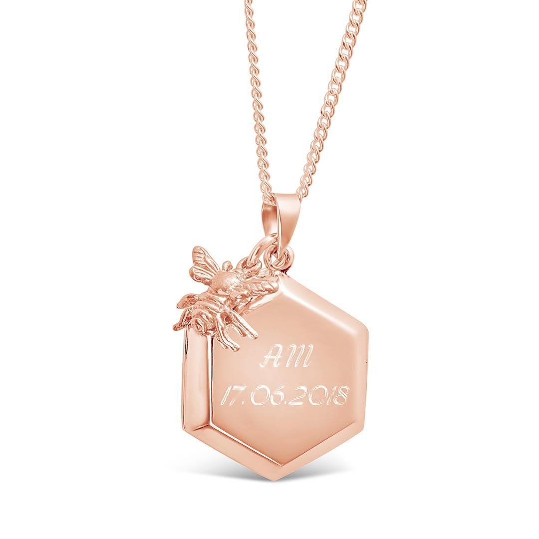 engraved bee locket in rose gold with charm on a white  background