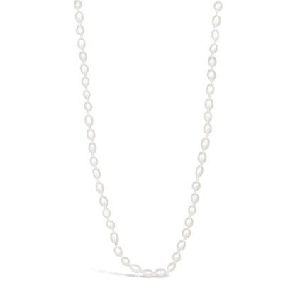 Ivory seed pearl necklace on a white background