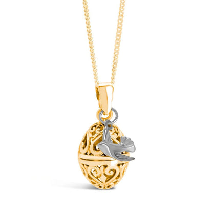 gold bird locket with silver bird charm on a white background