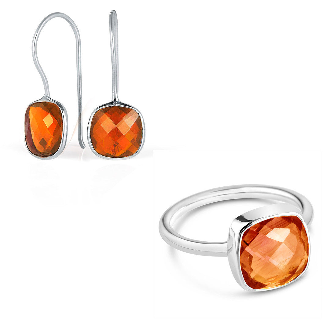 carnelian cocktail ring in silver and luminous earrings on a white background