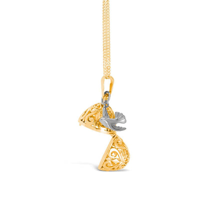 opened gold bird locket with silver charm attached on a white background