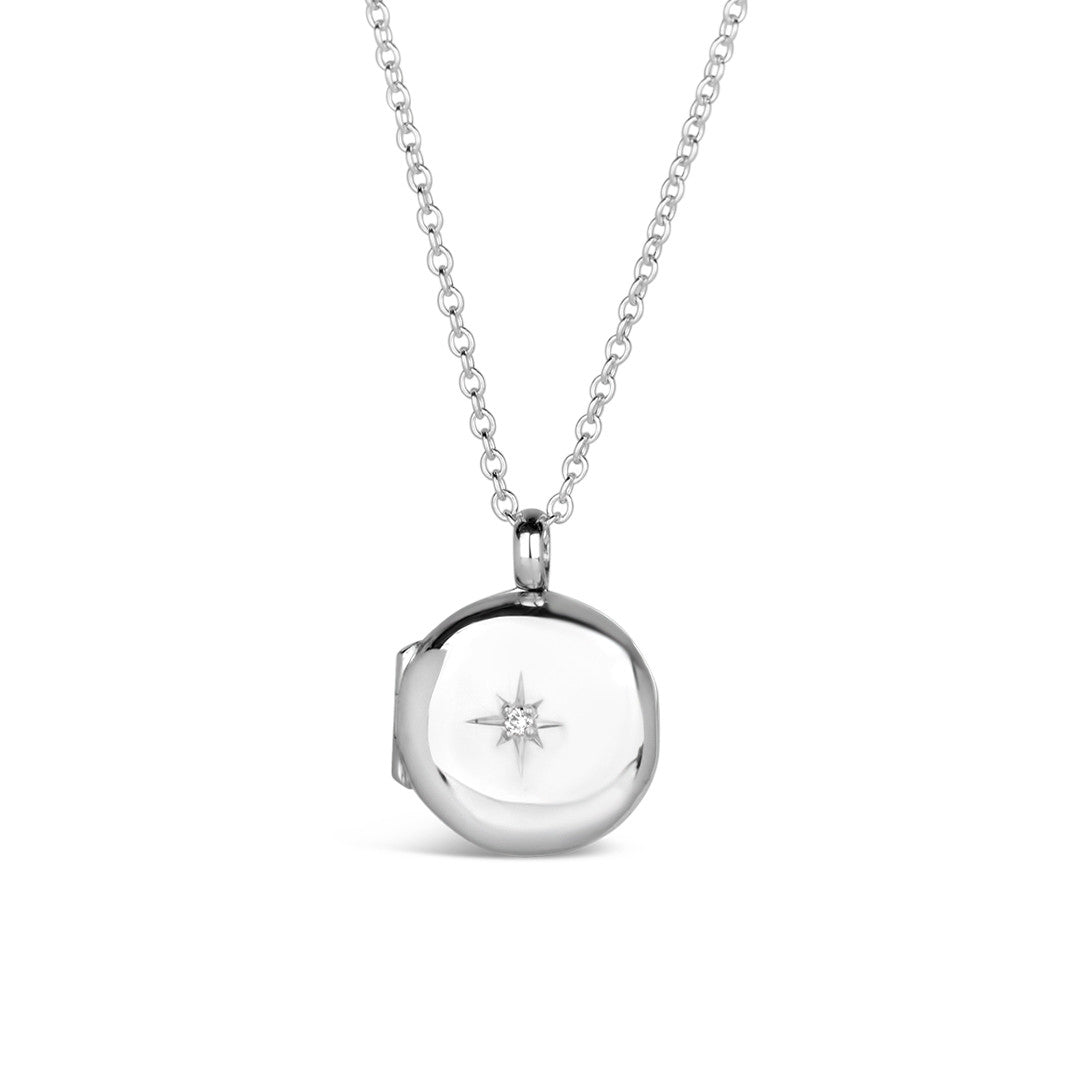 small round diamond locket in silver on a white background