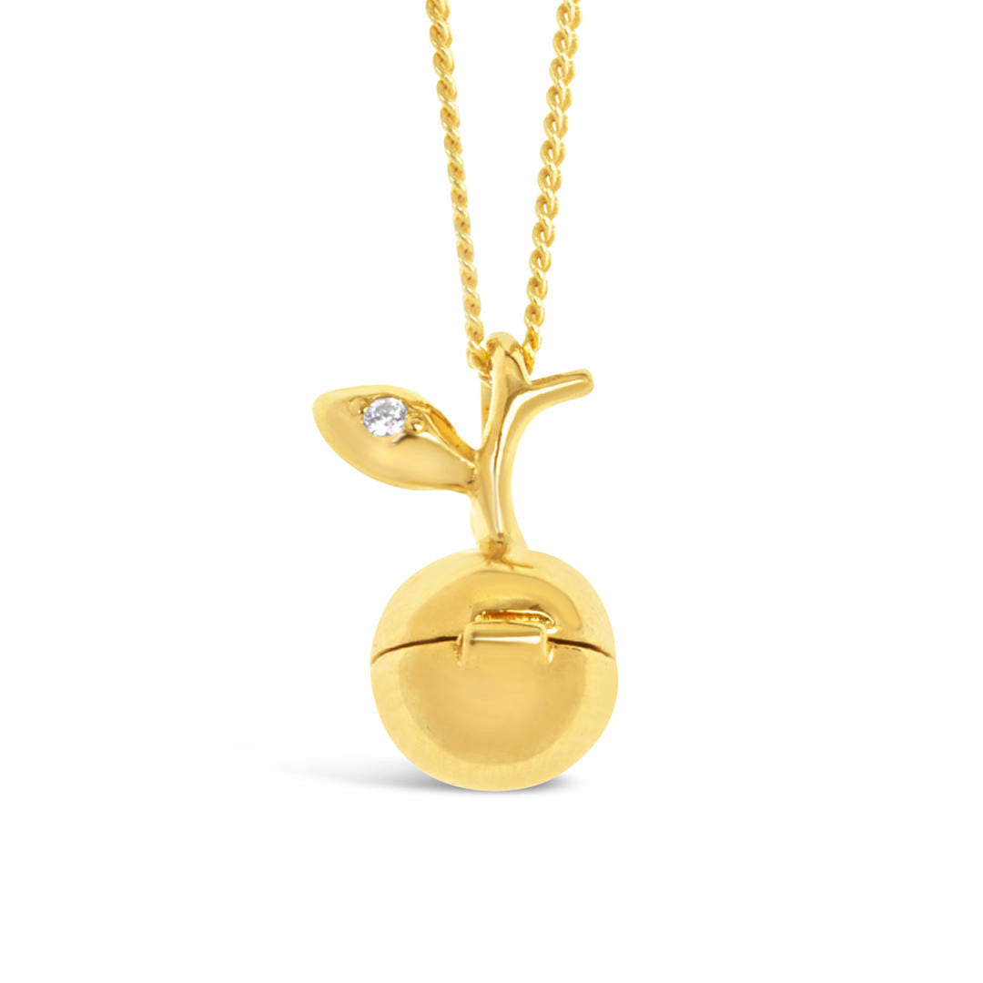 gold apple magical charm necklace on a white background