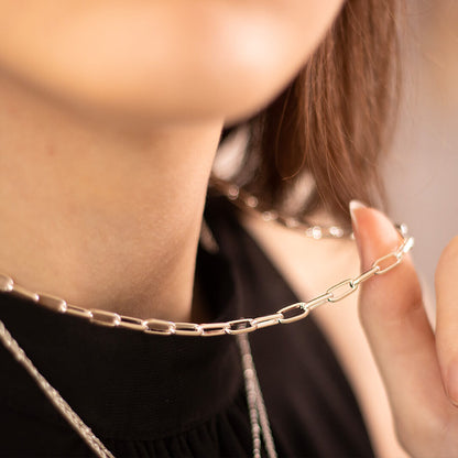 close up of model wearing paper clip chain necklace in silver