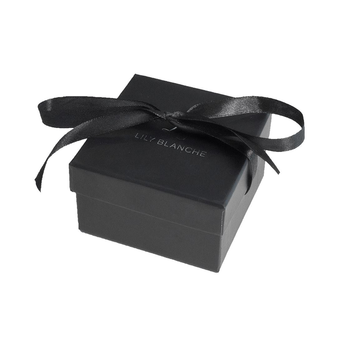 black ribbon-tied Lily Blanche gift box gift on a white background