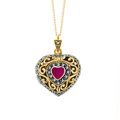 ruby vintage heart locket in gold on a white background