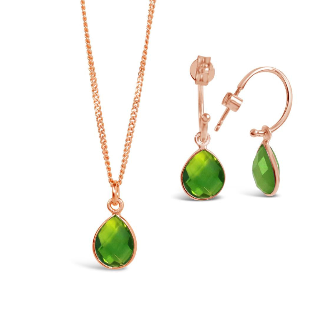 genuine peridot rose gold hoop earrings and matching pendant on rose gold chain on a white background