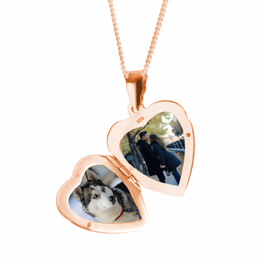 close up of opened heart locket in rose gold with two photos inside 