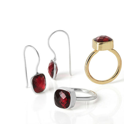 collection of garnet jewellery on a white background