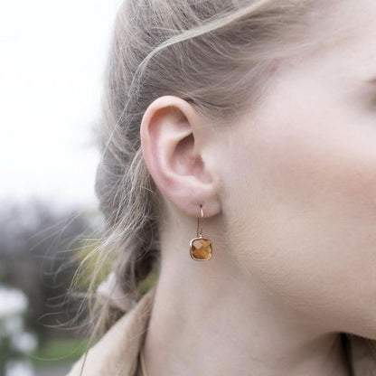 model wearing citrine earrings in rose gold