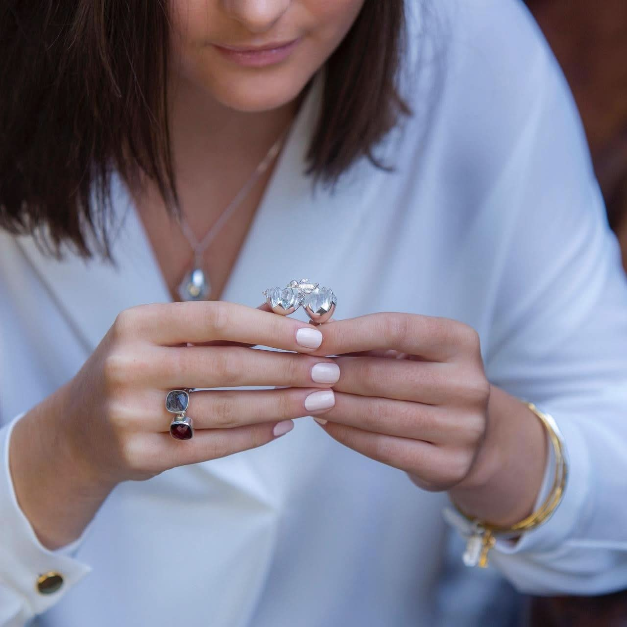 close up of model holding opened charming chick locket in silver