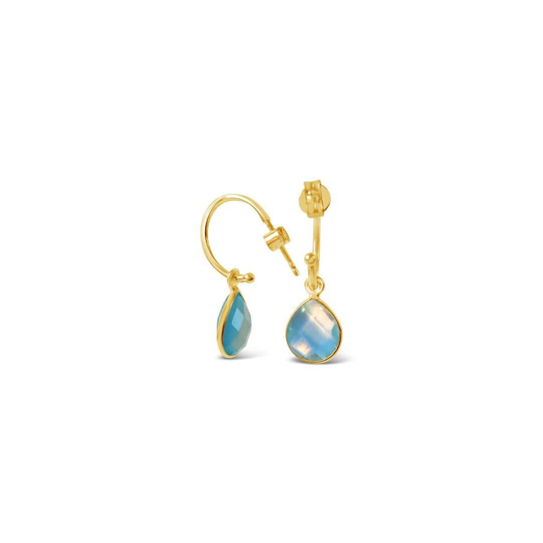 blue topaz drop hoop earrings in gold on a white background