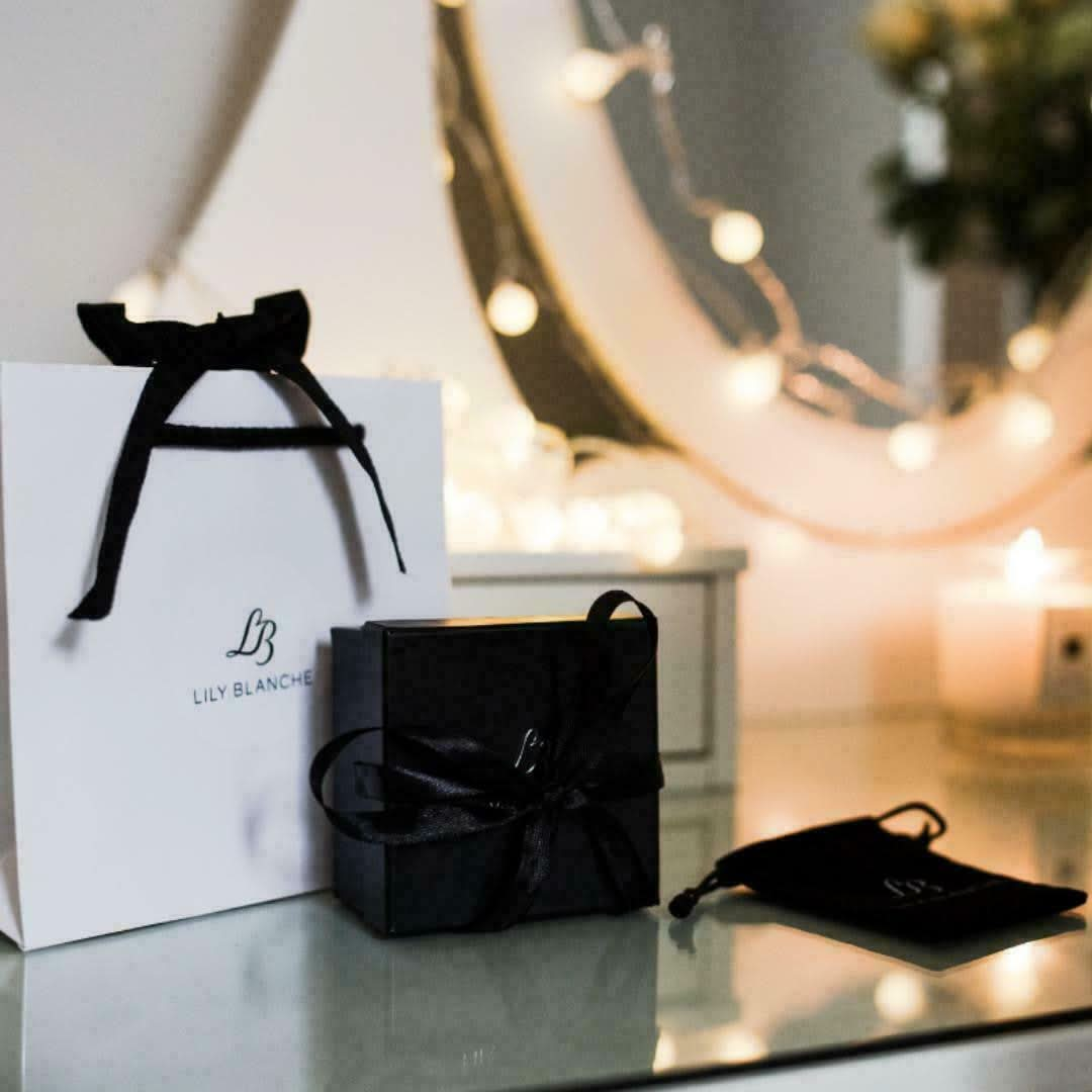 Lily Blanche white ribbon tied gift bag with black ribbon tied gift box