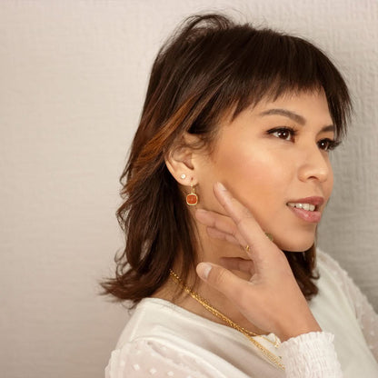 model wearing carnelian earrings in gold 