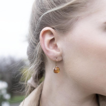 close up of model wearing citrine earrings in gold