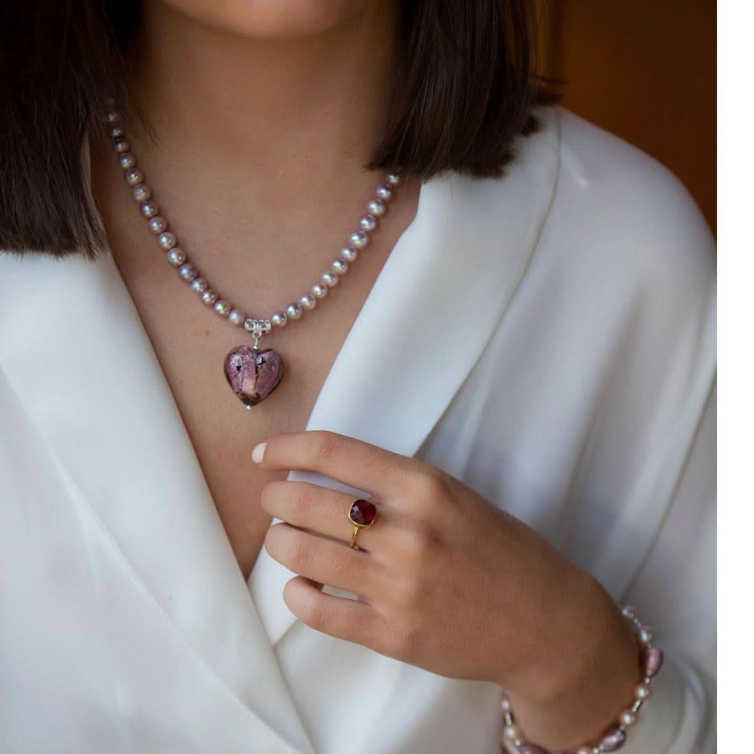 close up of model wearing dusk pearl heart necklace