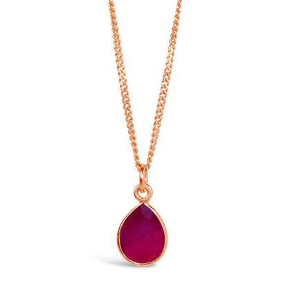 ruby charm necklace in rose gold on a white background