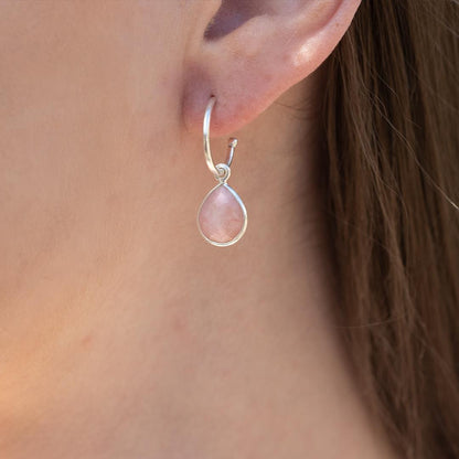 model wearing pink opal drop hoop earrings