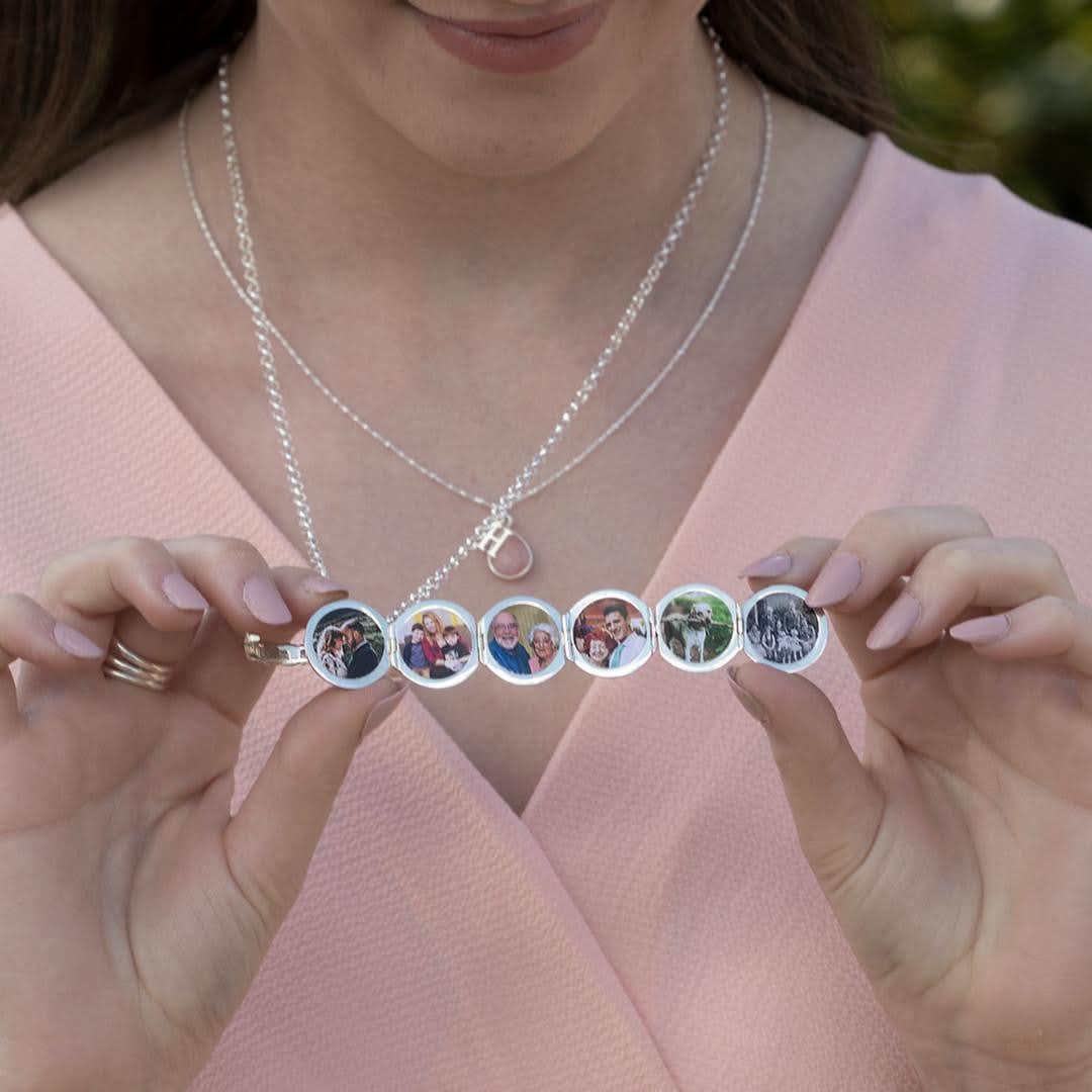 model in pink top holding white gold memory keeper locket with six photos