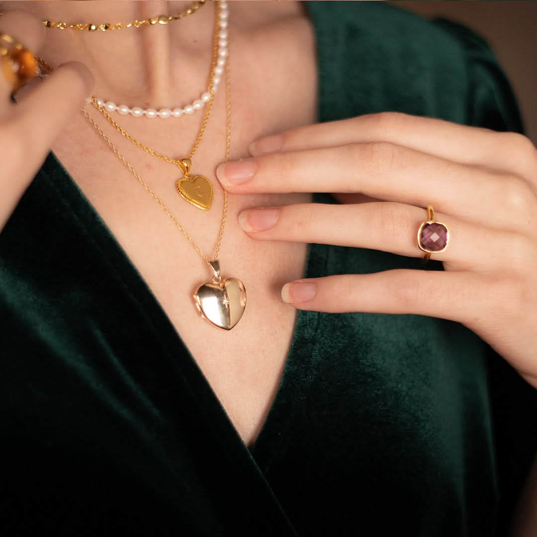 model wearing gold diamond heart locket