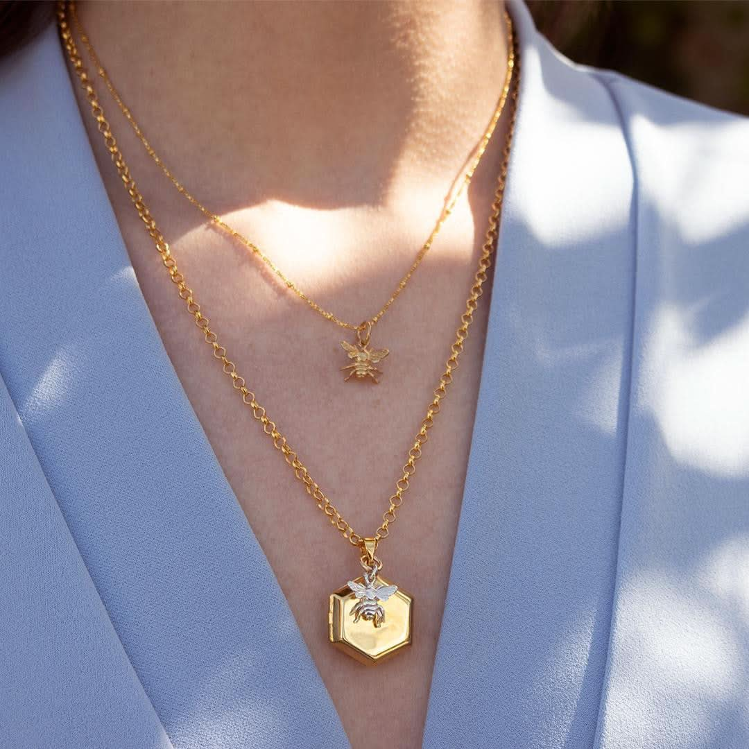 model wearing bee locket in gold with silver bee charm