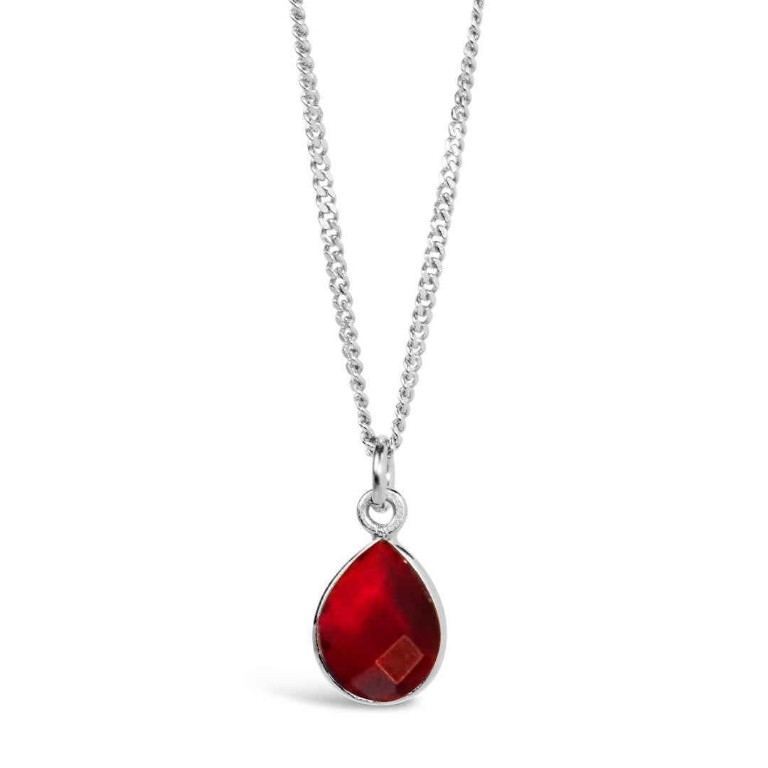 garnet charm necklace in silver on a white background