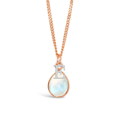 moonstone charm necklace in rose gold with silver initial charms on a white background 