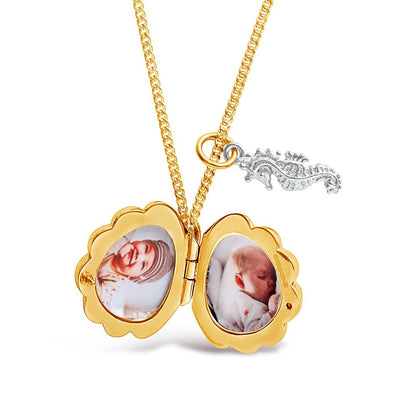 opened seahorse locket in gold with charm and photos inside
