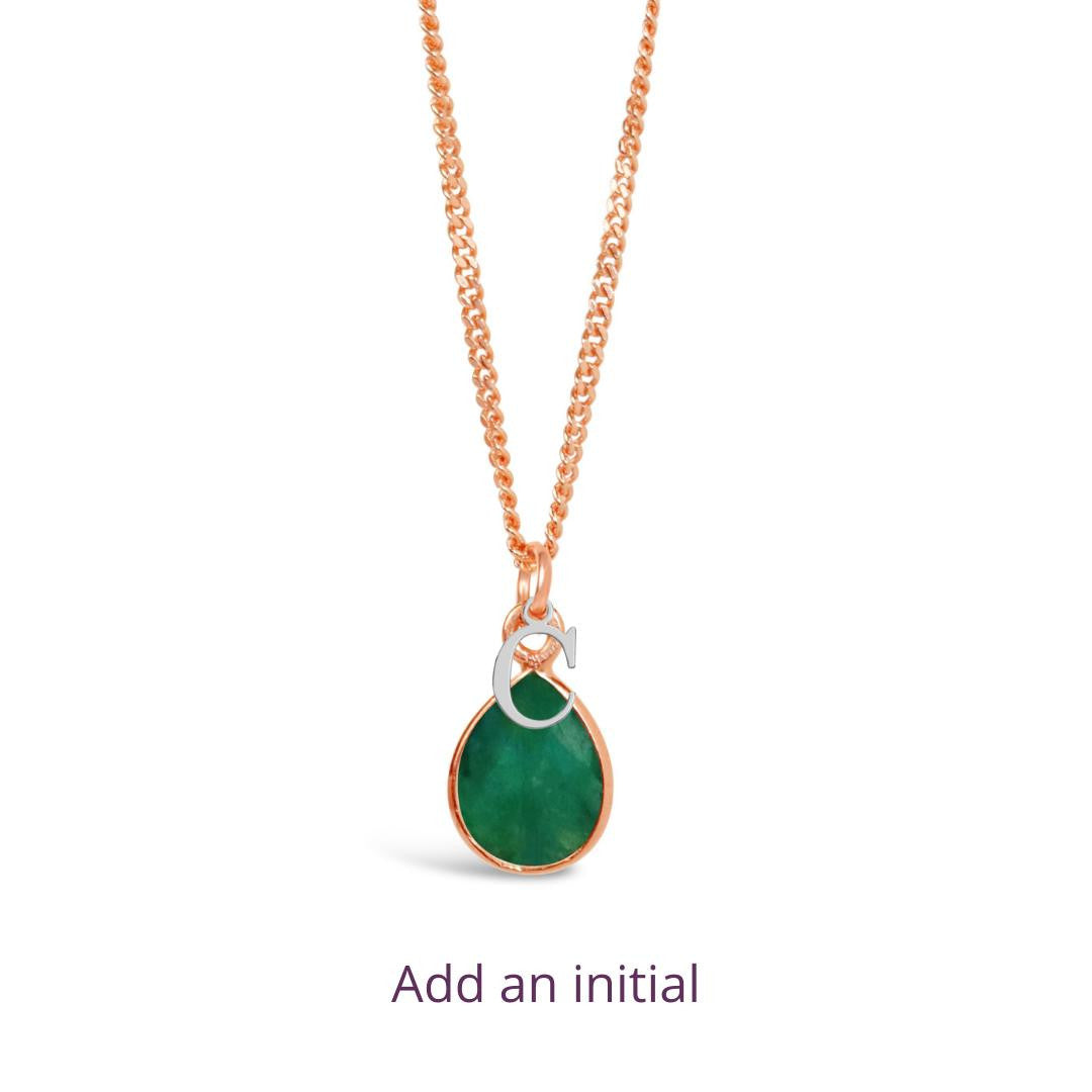 emerald charm necklace in rose gold with silver initial charm on a white background