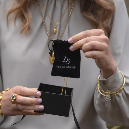 model using black anti-tarnish pouch to store her jewellery