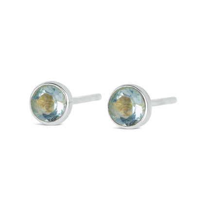 Blue topaz mini stud earrings in silver facing the front on a white background