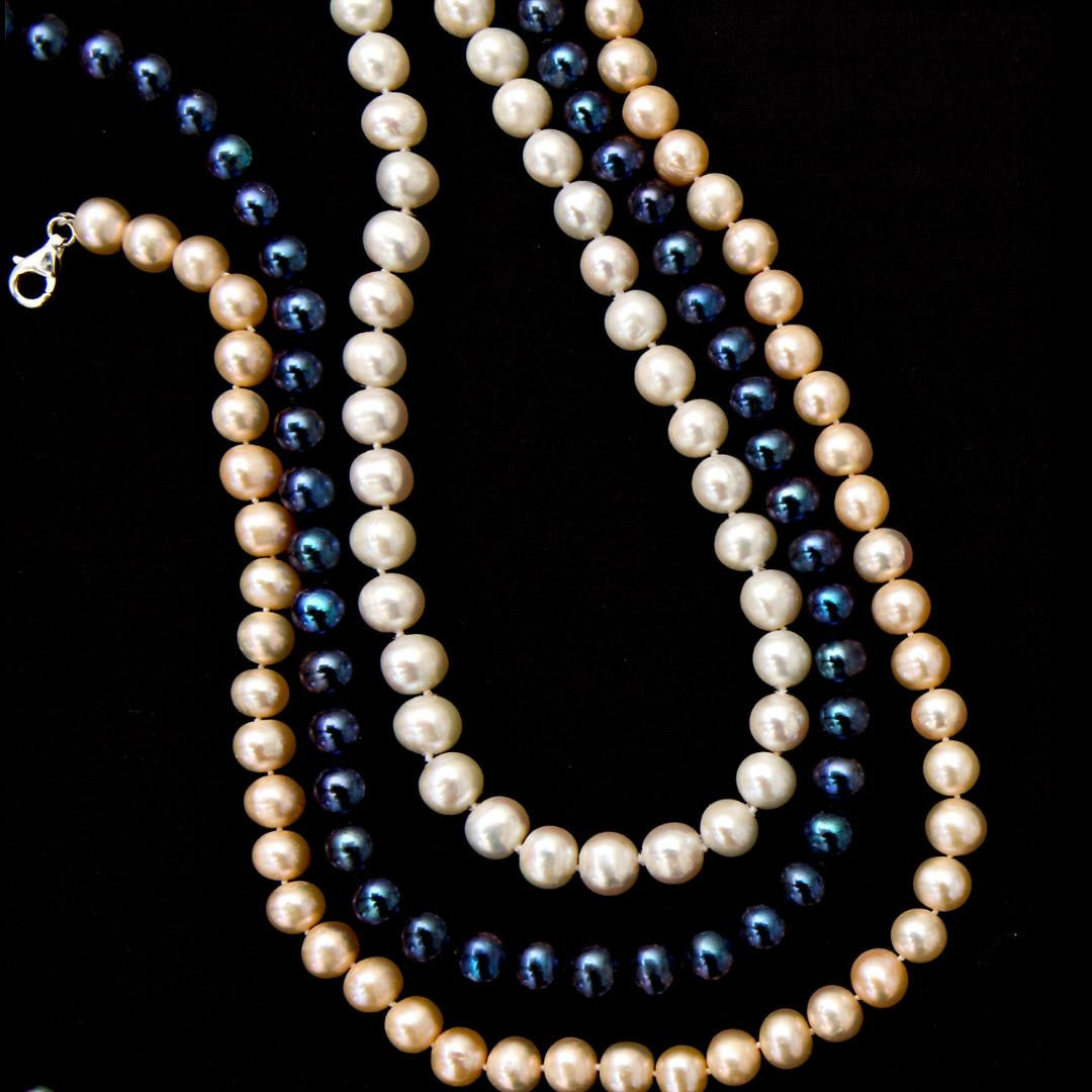 three classic pearl necklaces in ivory, champagne and midnight 