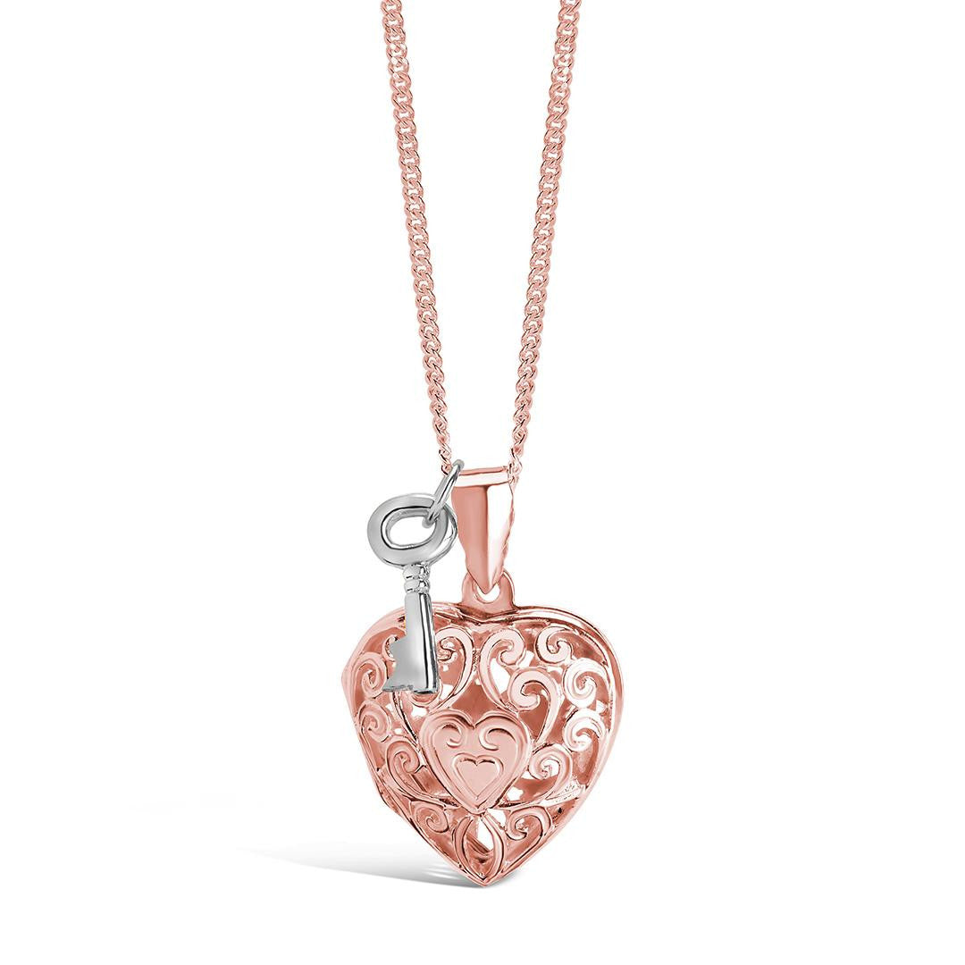 key locket in rose gold with silver key charm on a white background