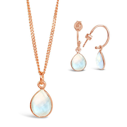 moonstone drop hoop earrings and necklace in rose gold on a white background