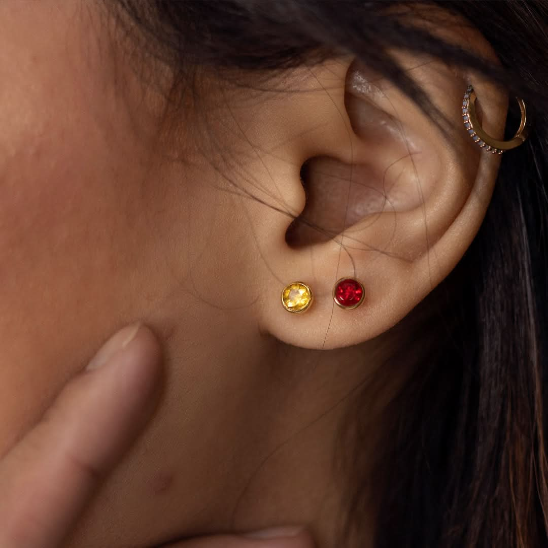 close up of model wearing citrine mini stud earrings in silver  