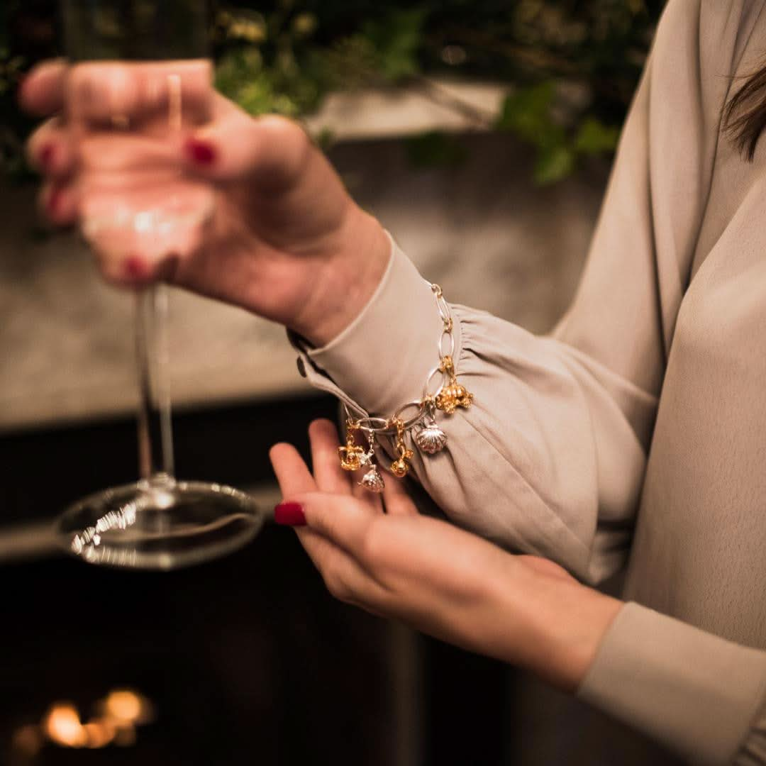 model wearing bracelet with magical charms attached 