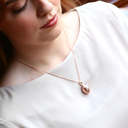 model wearing bird locket in rose gold