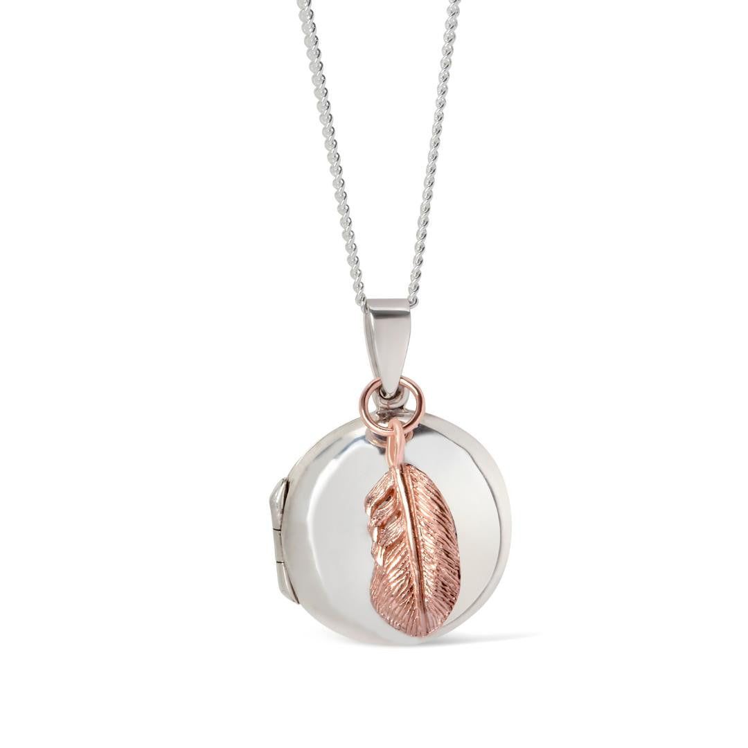 white gold feather locket with rose gold feather charm on a white background