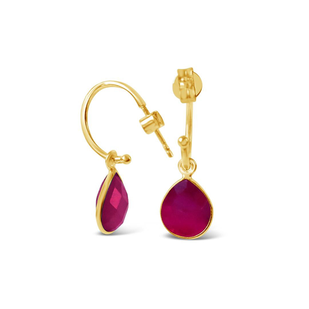ruby drop hoop earrings in gold on a white background