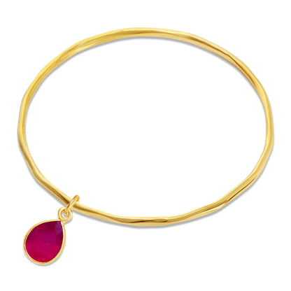 ruby charm bangle in gold on a white background