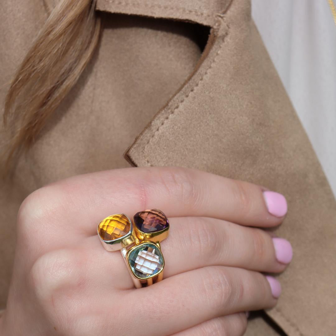 model wearing three cocktail rings with different gemstones