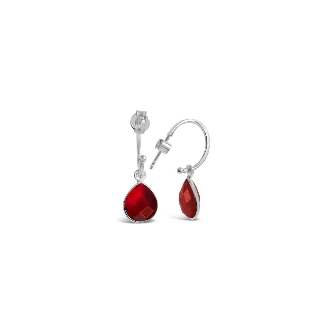 garnet drop hoop earrings in silver on a white background