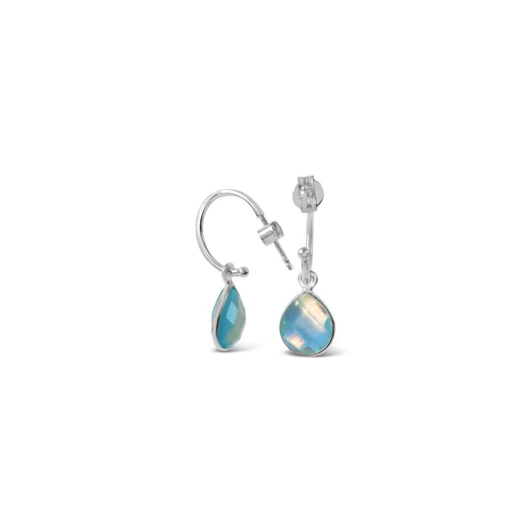 blue topaz drop hoop earrings in silver on a white background