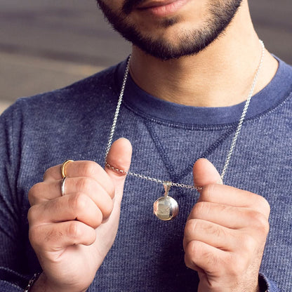 model wearing men's round locket necklace in white gold